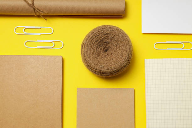 istock Mockup flat lay with different office accessories on yellow background 1877033482