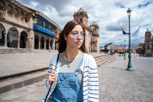 istock Medium shot of young Peruvian woman strolling in Plaza Mayor, Cusco, Peru 1877058152