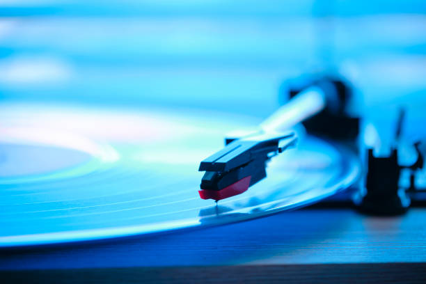 istock Vinyl record player with record on the background morning light from window with blinds. 1877067148