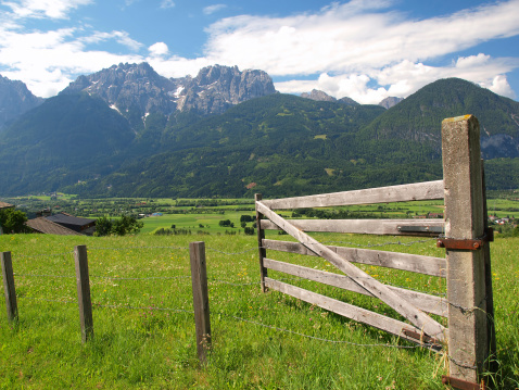 Alpine landscape with farm fence in front, Carinthia, Austria.