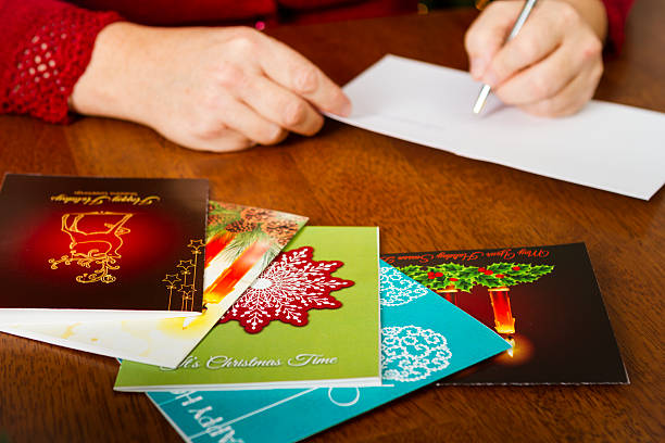 istock Woman Writing Holiday Cards On Table 187709446