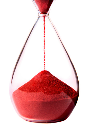 Red hourglass on white background.