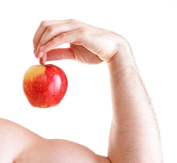 istock Athletic sexy male body builder holding red apple 187710021