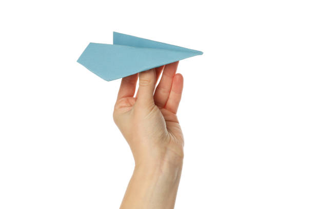 istock Female hand with paper plane isolated on white background 1877115495