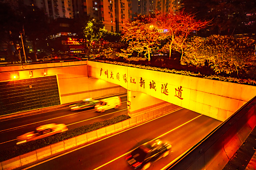 Guangzhou City, China - April 3, 2019: The Chinese character Pearl River New Town tunnel is carved on the top of the tunnel bridge, creating a night time architectural scene, Guangzhou City, Guangdong Province, China