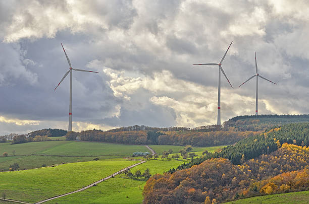 istock Rolling landscape with wind turbines on cloudy day 187713407