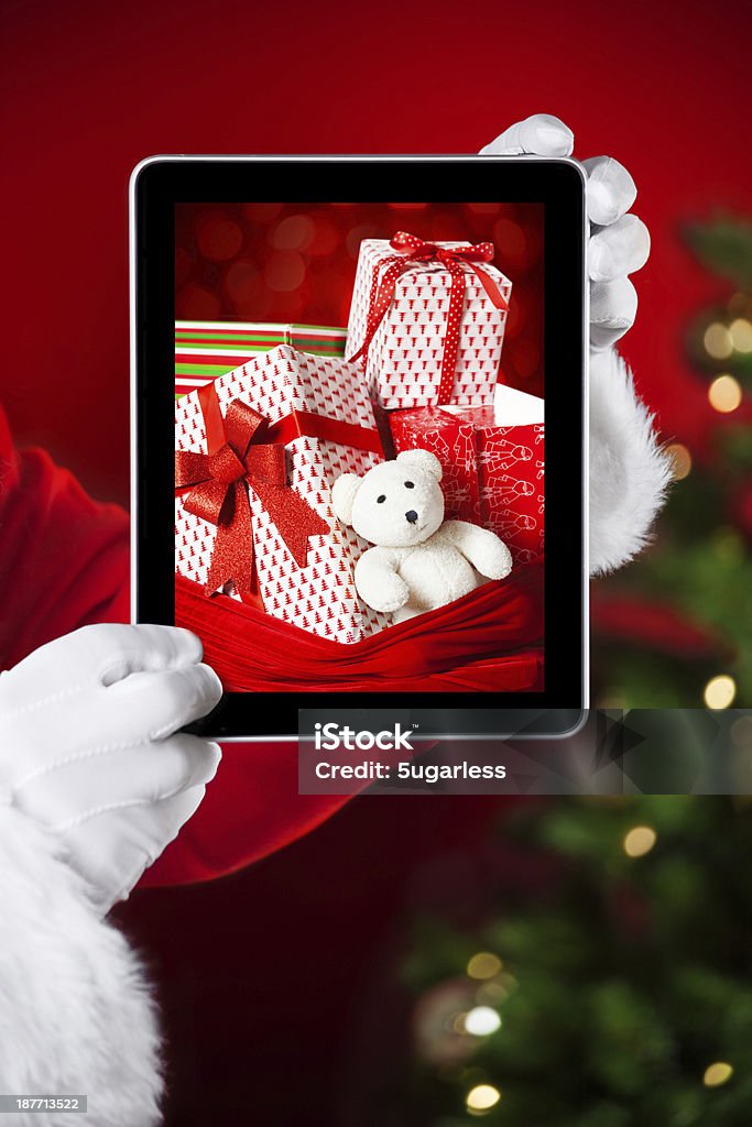 Santa holding einen tablet mit Foto von Weihnachten präsentiert - Lizenzfrei Ausrüstung und Geräte Stock-Foto