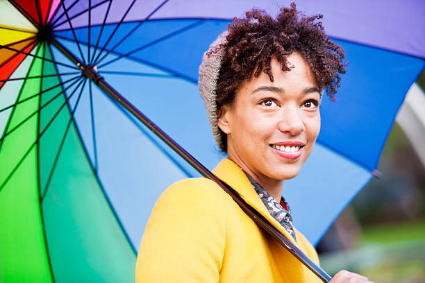 istock Beautiful multi-racial woman with umbrella 187713606