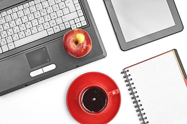 istock Laptop and office supplies on white 187714857