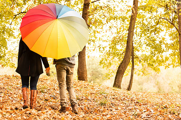 istock Couple behind colorful umbrella 187715431