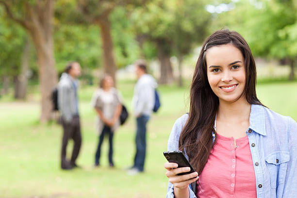 istock Portrait of a female student using her smartphone 187716470