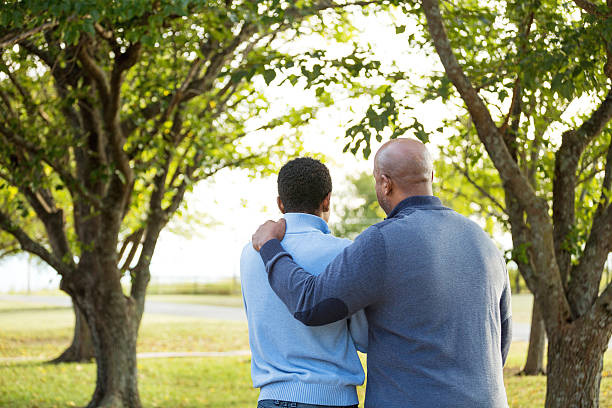 Father and son Father and son serious black teen stock pictures, royalty-free photos & images