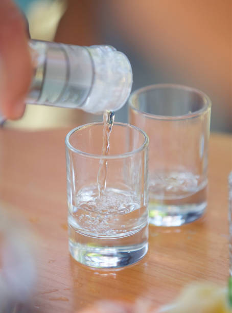 istock Pour the alcoholic beverage vodka into a glass. 1877184444