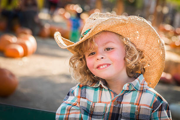 istock Young Boy in Cowboy Hat at Pumpkin Patch 187719291