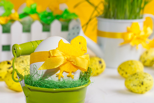 Easter decor with selective focus. Holiday still life with decorative eggs in a bucket with copy space for text