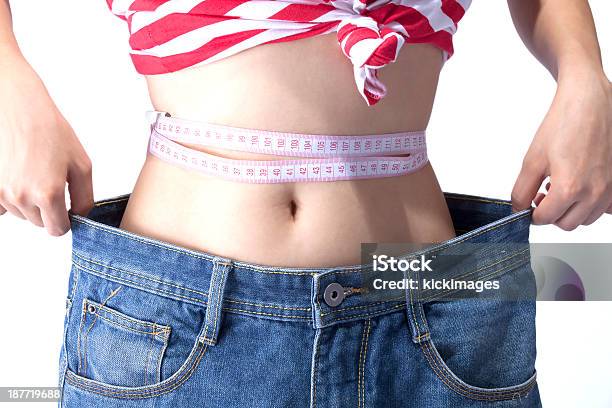 Woman With Measuring Tape Wearing Loose Jeans Stock Photo - Download Image Now - Abdomen, Achievement, Adult