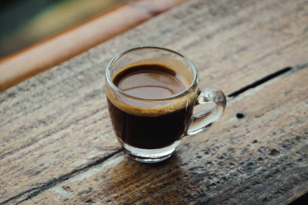 istock Hot espresso on a wooden table 1877210429