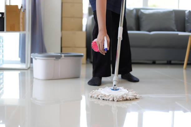 istock Cleaner is mopping floors at home with a mop. 1877220381