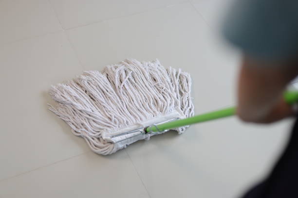 istock Cleaner is mopping floors at home with a mop. 1877220521