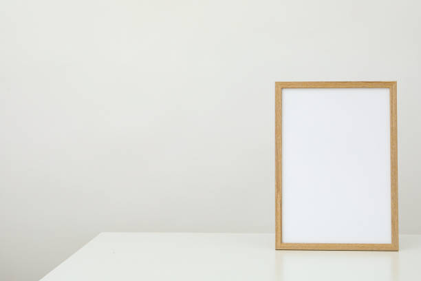 istock Wooden photo frame on the table on a white background 1877237580