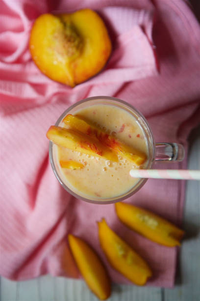 istock Cocktail or milk drink peach yogurt is poured into a glass bowl 1877241239