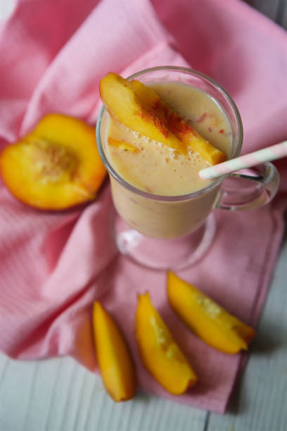 istock Cocktail or milk drink peach yogurt is poured into a glass bowl 1877243015