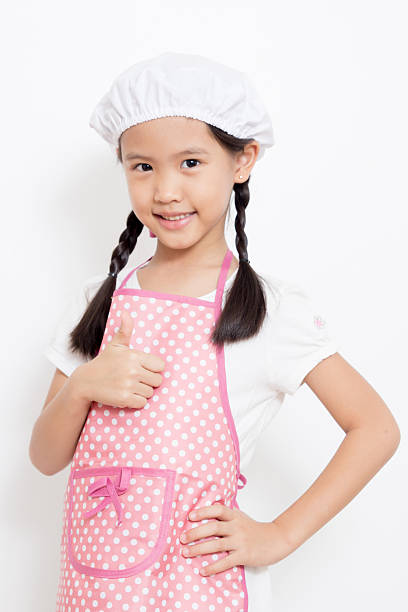 istock Pretty Asian cute chef wearing pink apron and thumb up 187726251