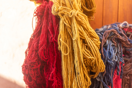 Dyed wool hangs in the street market