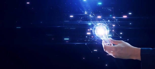 istock Businessman holding a bright light bulb on a dark blue background. Innovation changes the world, new creativity or imagination arises. 1877302416
