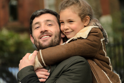 Father and Daughter together outdoors.