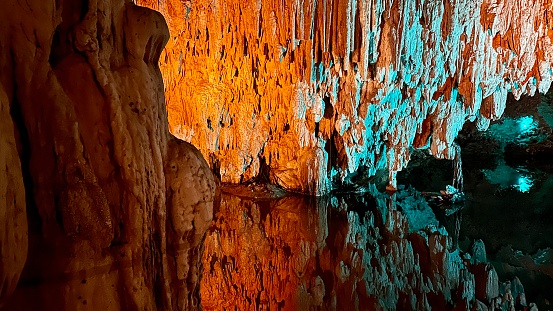 Inside a big limestone cave with an underground sea water lake. This is Cuevas del Drach in Mallorca, Spain.