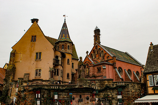 Image of the sightseen of Eguisheim, with the fountain and the church. The image was taken in December 2022