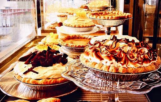 The ideal kitchen or coffee shop photo featuring a wide variety of pie…Meringue, Double Crust Fruit Filled, Boston Cream, Pumpkin, and a wide selection of quiches.