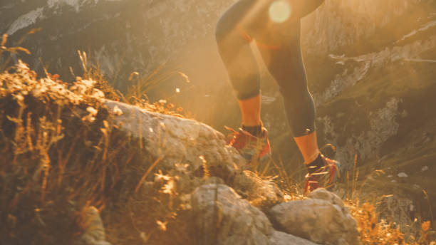 istock Low Section of Determined Female Sprinter Moving Up on Rocky Mountain During Bright Day 1877338376