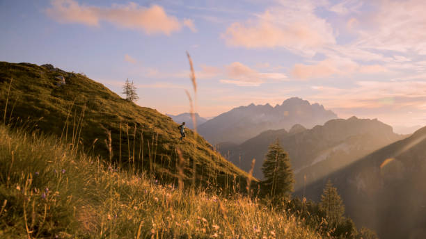 istock High Angle View of Female Sprinter Running Down Hill Overlooking Rocky Mountains Against Sky 1877338924