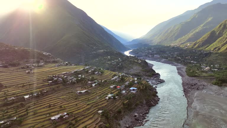 Aerial Drone Sunrise view of Besham city and Rice Field Valley with Indus River in the Shangla District of Khyber Pakhtunkhwa, Pakistan. Located on the right bank of the Indus River in Route of Karakoram Highway