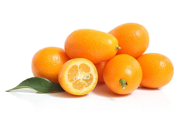 Kumquat with leaf on a white background