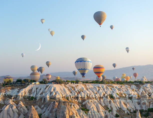 istock Hot air balloons over a rock 1877369958