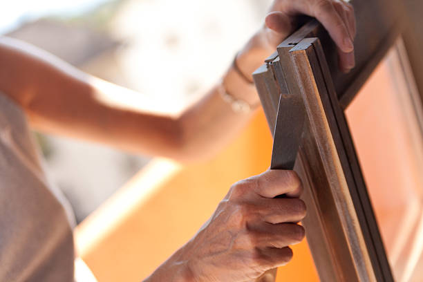 istock Woman polishing a window with putty knife 187738701