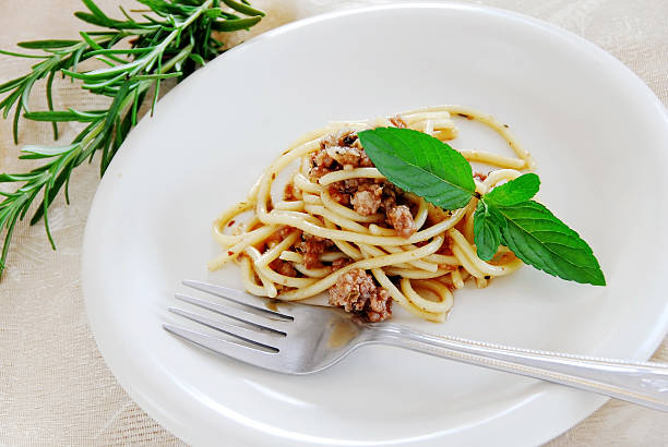 Spaghetti with minced meat small portion of spaghetti mixed with minced meat served on white plate serving size stock pictures, royalty-free photos & images