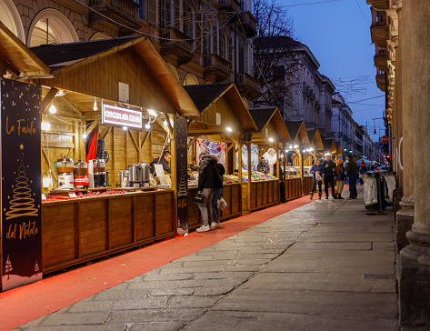 Turin, Piedmont, Italy - December 22, 2023: Christmas market in the old town, at night.