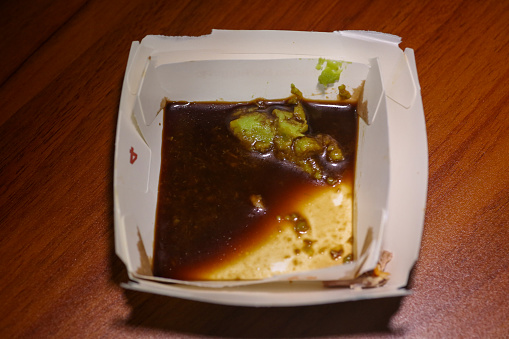 Wasabi and soy sauce in a paper container
