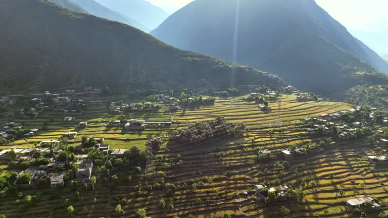 Aerial Drone Sunrise view of Besham city and Rice Field Valley with Indus River in the Shangla District of Khyber Pakhtunkhwa, Pakistan. Located on the right bank of the Indus River in Route of Karakoram Highway