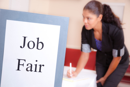 Unemployed, hispanic woman registers for a local Job Fair.