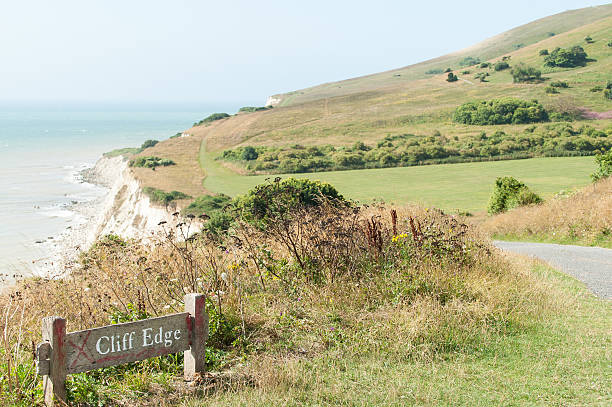 istock Cliff edge danger sign on South Downs Way, Eastbourne, UK 187742412