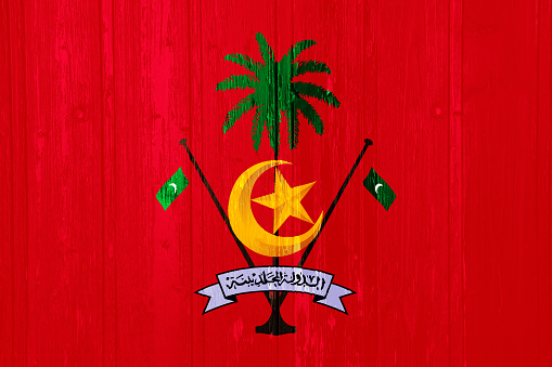 Flag and coat of arms of Republic of Maldives on a textured background. Concept collage.