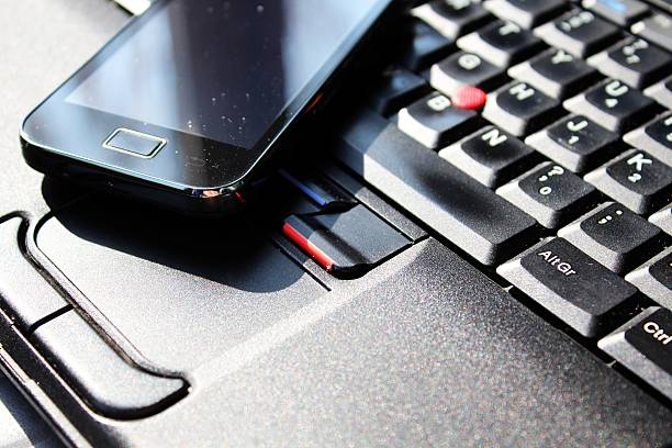 istock Smart phone on the keyboard of laptop 187744061