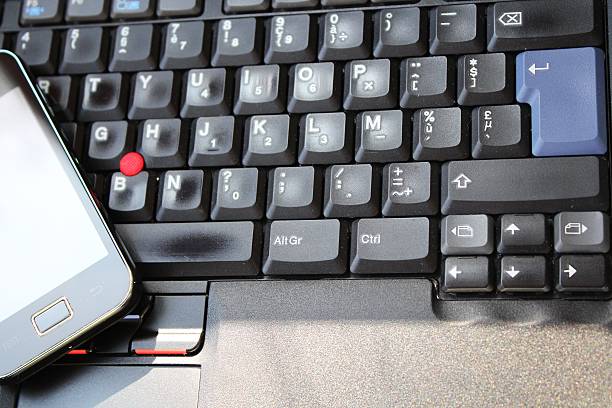 istock Smart phone on the keyboard of laptop 187745103