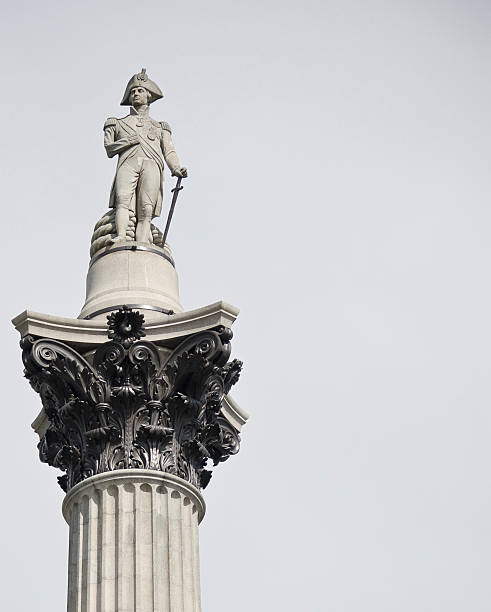 Famous statue of Admiral Nelson on Trafalgar Square in London, UK, on blue clear sky.