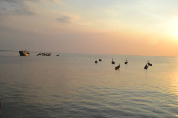 istock beautifull sunset with traditional boats 1877468293